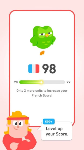 Duolingo French score 98. Eddy cheers to level up, with green owl mascot on screen.